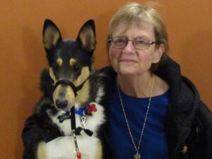 woman poses next to a smooth coat collie