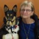 woman poses next to a smooth coat collie