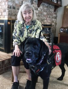 woman with black service dog