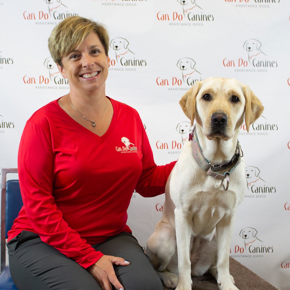 Denise Yokom sitting with a dog