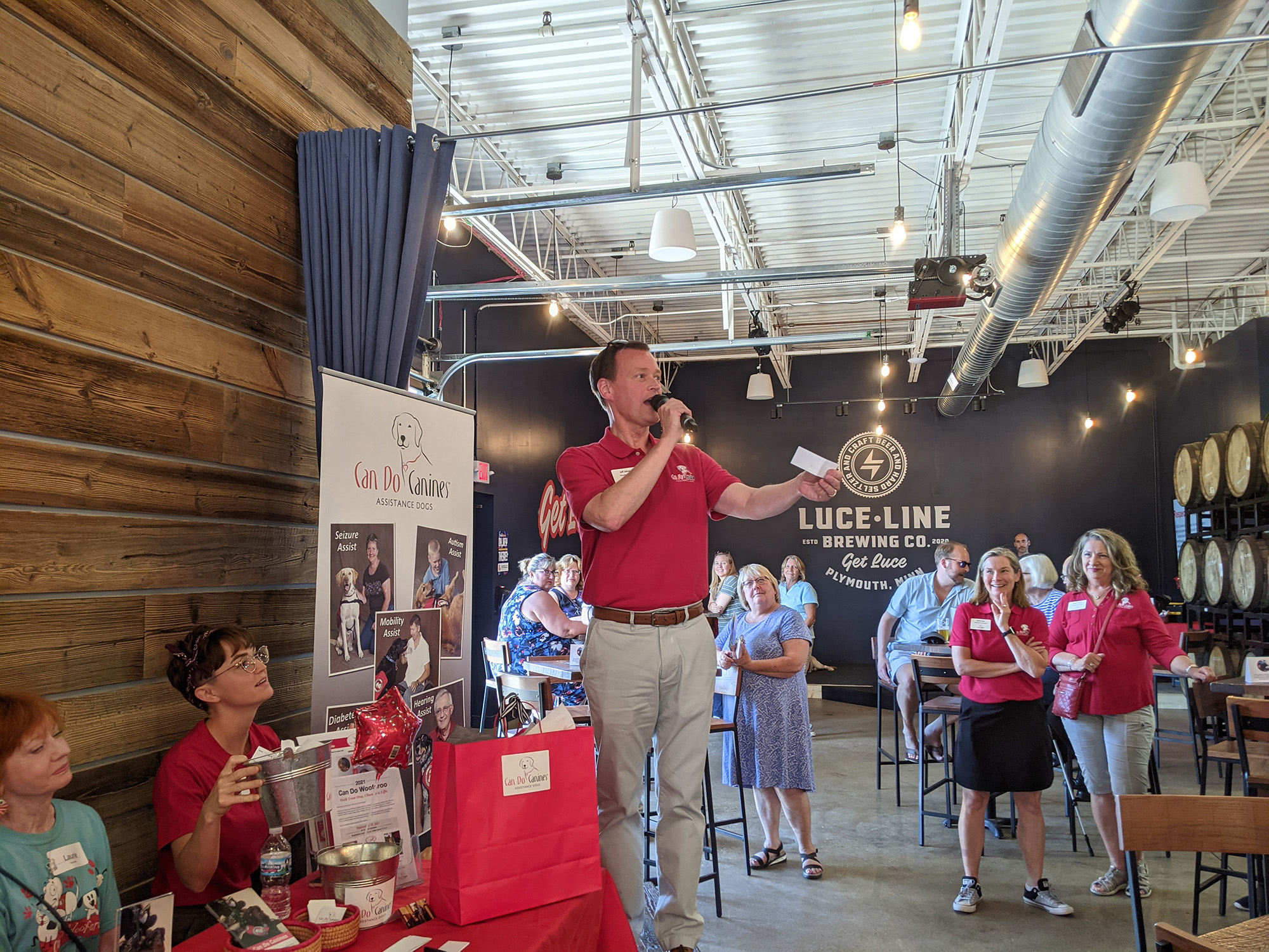 man in red shirt making an announcement