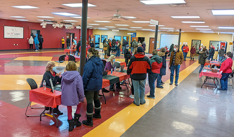 large group of people mingling in large open room