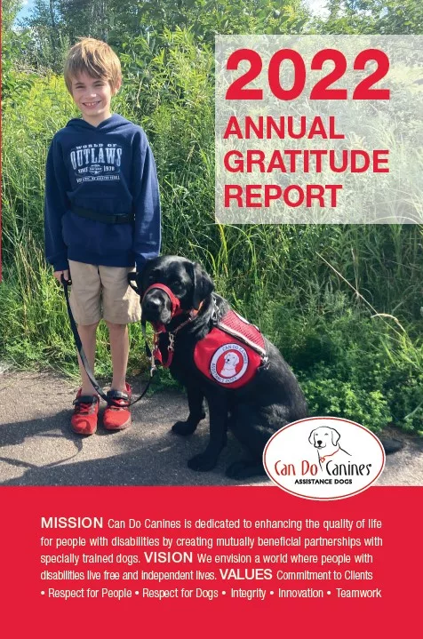 Photo of young boy standing on sidewalk and smiling at camera while holding leash of black Lab service dog. Headline reads 2022 Annual Gratitude Rerport with a Can Do Canines logo