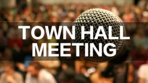 blurry image of crowd with mircrophone in foreground and text "Town Hall Meeting"