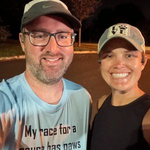 Man and a woman posing for a selfie before a run.