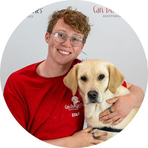 Photo of a man posing with a yellow Lab mix