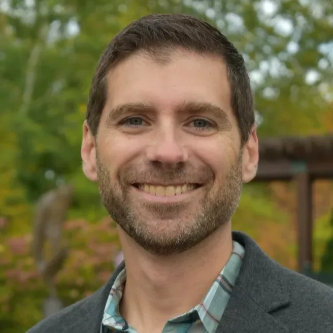 Man smiling and looking at the camera.